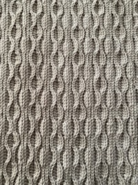 a close up of a grey knitted blanket