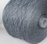 a grey cotton thread on a white background