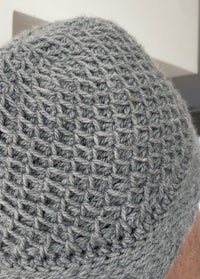 a gray knitted beanie on a man's head