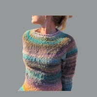 a woman wearing a colorful knit sweater