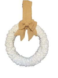 a white crochet wreath with a brown bow