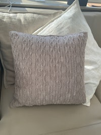 a pillow on a couch with pillows on it