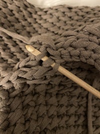 a knitted sweater with a knitting needle in it