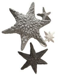 three crocheted starfish on a black background