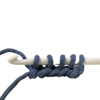 a crochet hook with a blue yarn on it